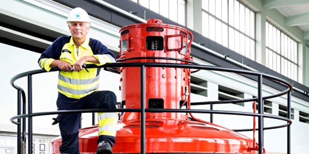 Man standing in the machine hall of a hydropower plant